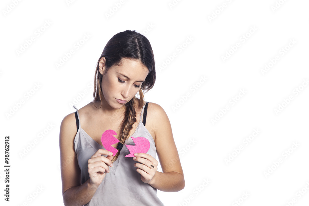 Portrait of sad young woman holding broken heart in hands, about to cry, isolated white background. Negative emotion Portrait of sad young woman holding broken heart in hands, about to cry, isolated white background. Negative emotion