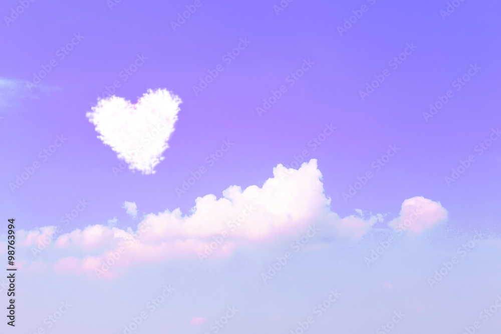 Violet sky background with clouds in heart shape