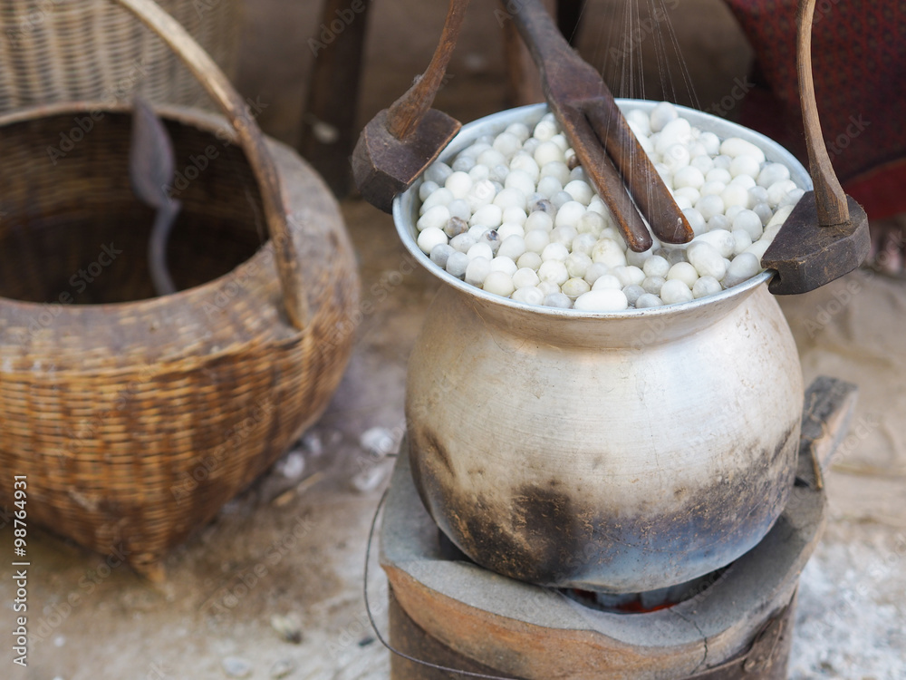 Boiling cocoon silkworm in a pot to prepare silk thread Boiling cocoon silkworm in a pot to prepare silk thread