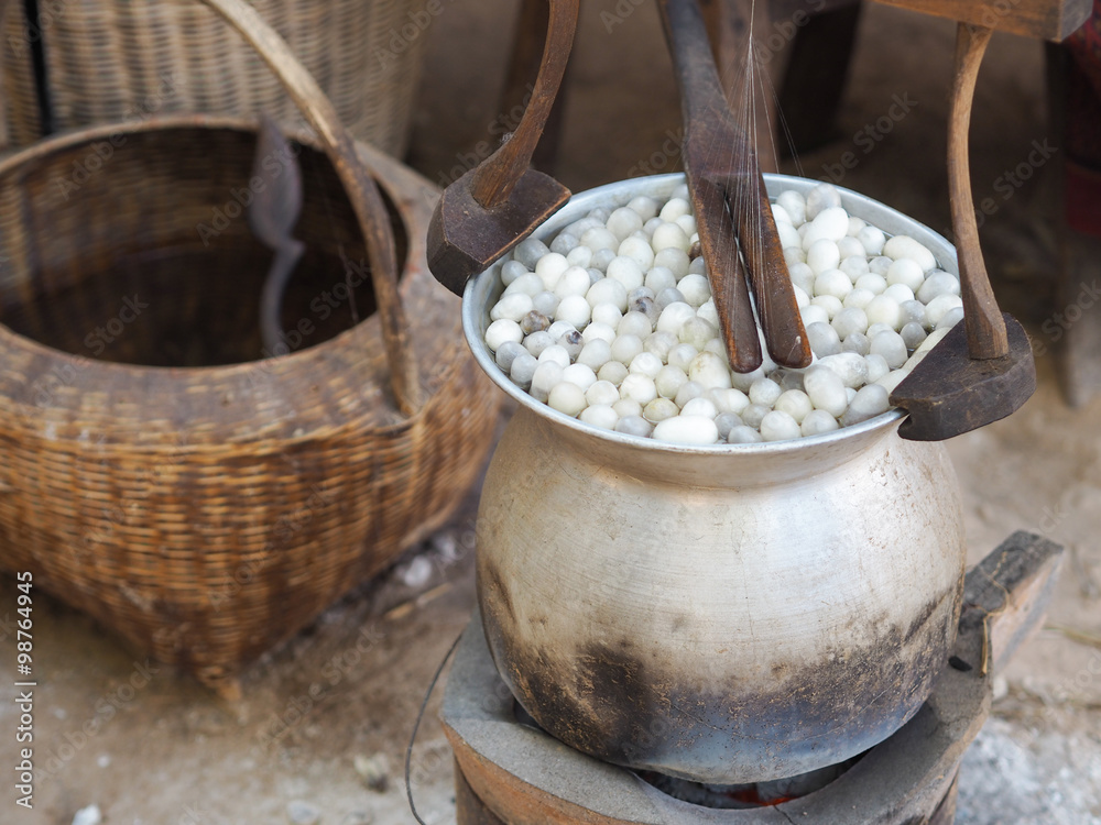 Boiling cocoon silkworm in a pot to prepare silk thread Boiling cocoon silkworm in a pot to prepare silk thread