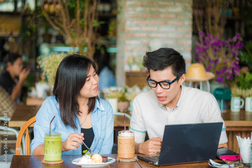 Young businessman and businesswoman using laptop Young businessman and businesswoman using laptop