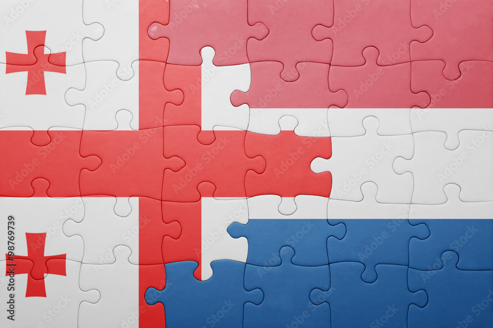 Fototapeta premium puzzle with the national flag of netherlands and georgia