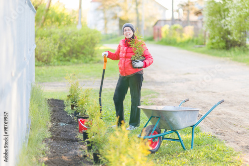 Portrait of a handsome young woman working in her garden