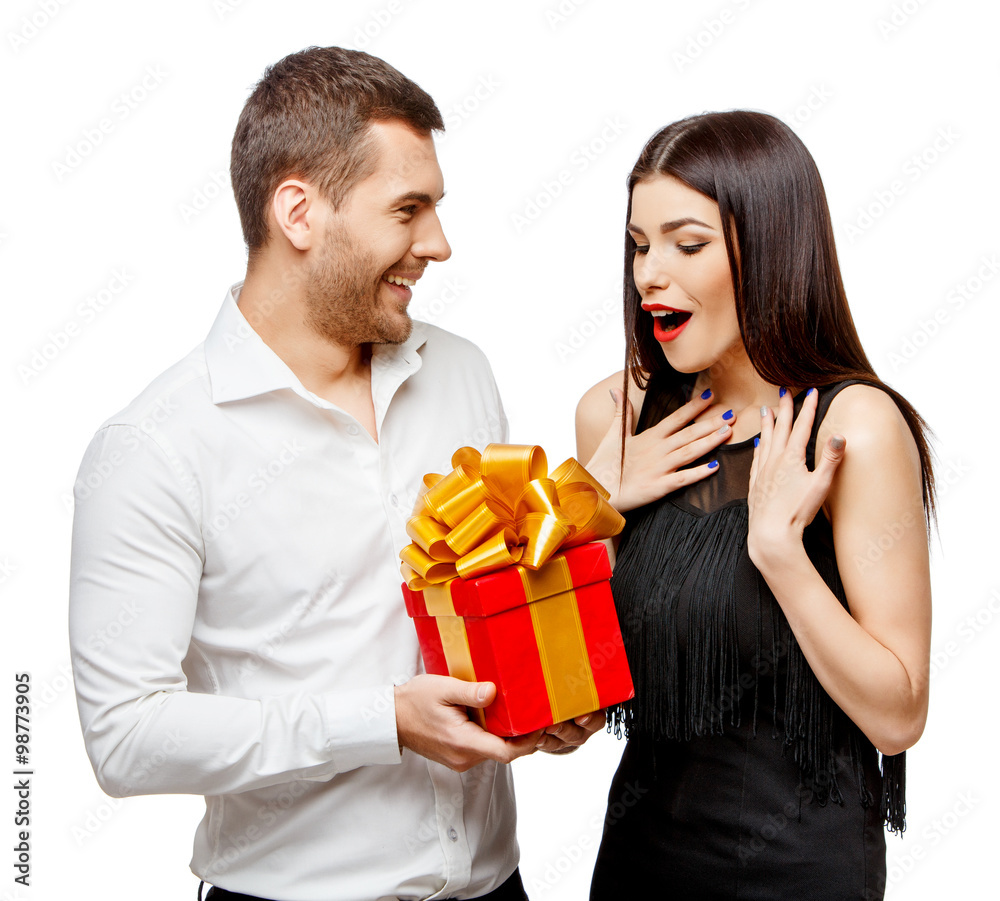 Young beautiful couple with present isolated on white Young beautiful couple with present isolated on white
