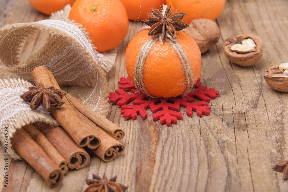 Fototapeta premium Still life with tangerines on a wooden background.