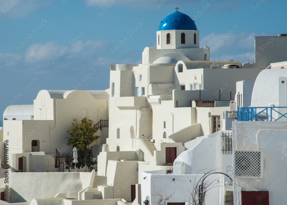 A blue-domed Greek Orthodox church in Oia town on the island of Santorini, Greece