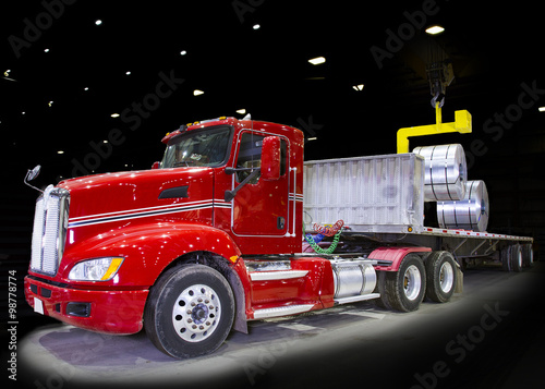 Red truck being loaded - black bay