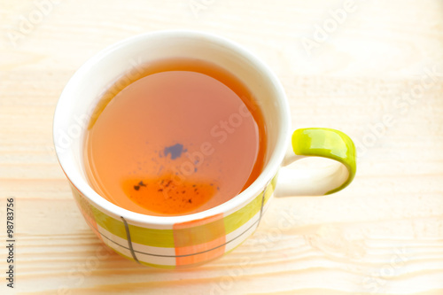 Cup of tea on bright wooden background