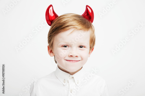 Little cute emotional boy with red horns on his head