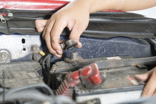 Close-Up hand of Mechanic checking car battery