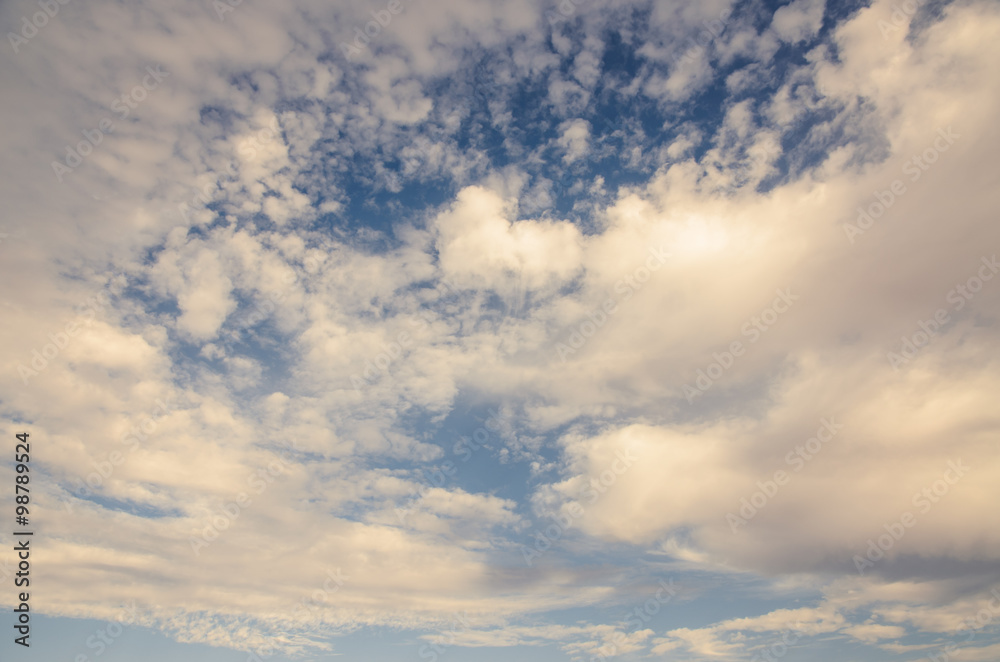 Fototapeta premium Cumulus whithe clouds in the blue sky at sunset