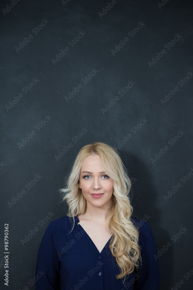 Blond woman in shirt against chalkboard, copyspace Blond woman in shirt against chalkboard, copyspace