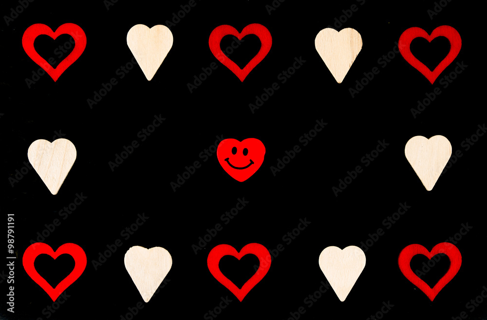 Heart shapes symbols and smiling emoticon isolated on black, available copy space, love concept