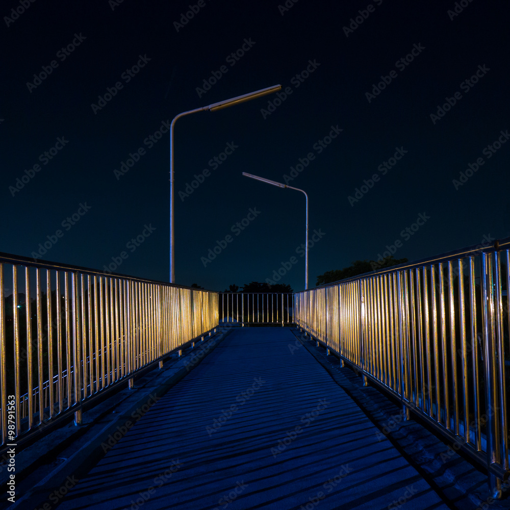 Footbridge with light reflection at night