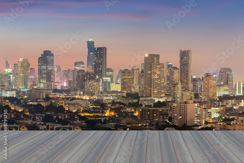 Opening wooden floor, city downtown background skyline aerial view photo