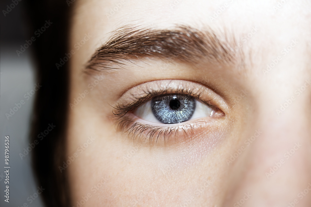 Naklejka premium An insightful beautiful look boy's blue eye