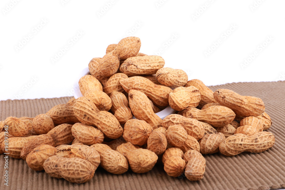 Monkey nuts, peanuts or groundnuts in shells, isolated on a white background Monkey nuts, peanuts or groundnuts in shells, isolated on a white background