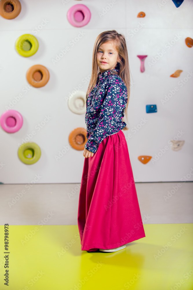 The little girl posing in a playroom The little girl posing in a playroom