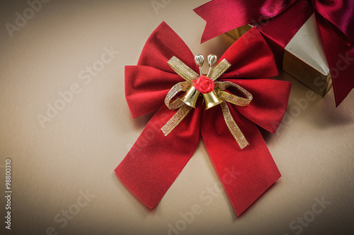 Packed present box bow on golden background holidays concept
