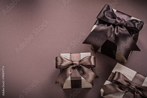 Set of wrapped present boxes on brown surface holidays concept