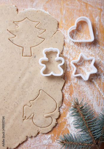 Dough for gingerbread cookie and cookie cutters in different sha