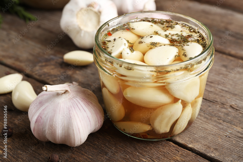 Garlic with spices on wooden table