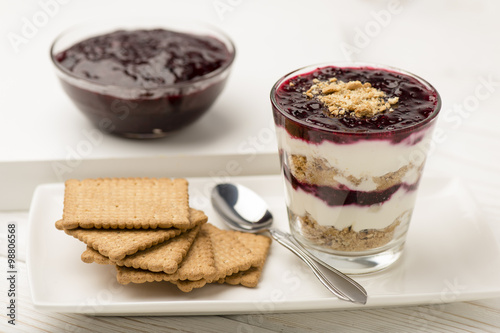 Healthy dessert with natural yogurt, full grain biscuits and black currant jam.