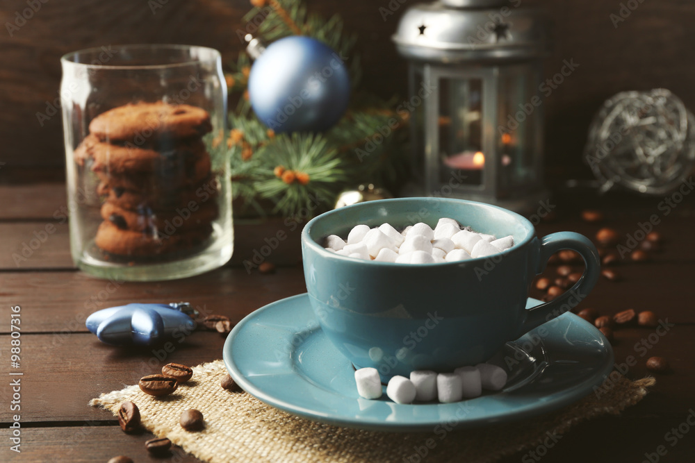 Mug of hot chocolate with marshmallows, fir tree branch on wooden background Mug of hot chocolate with marshmallows, fir tree branch on wooden background
