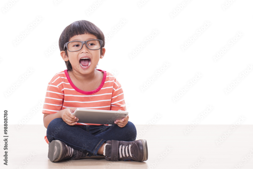 Cute boy playing a game on computer tablet Cute boy playing a game on computer tablet