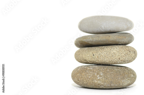 Photography Four stacked spa stones on a white background.