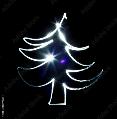 Christmas tree made with blue flashlight on a black