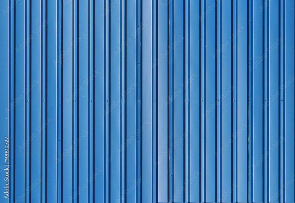Blue metal corrugated fence with vertical bars