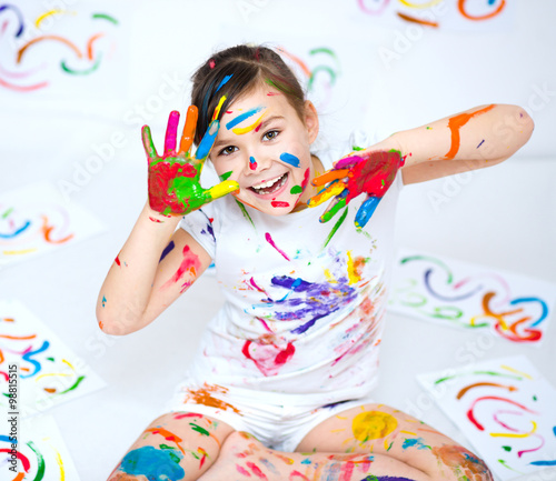 Cute girl playing with paints