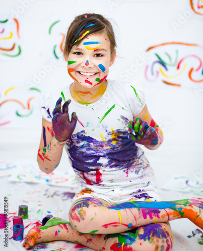 Cute girl playing with paints