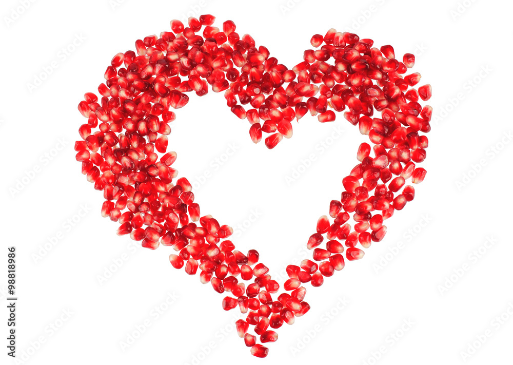Valentine's heart shape made by pomegranate seeds (isolated on white) Valentine's heart shape made by pomegranate seeds (isolated on white)