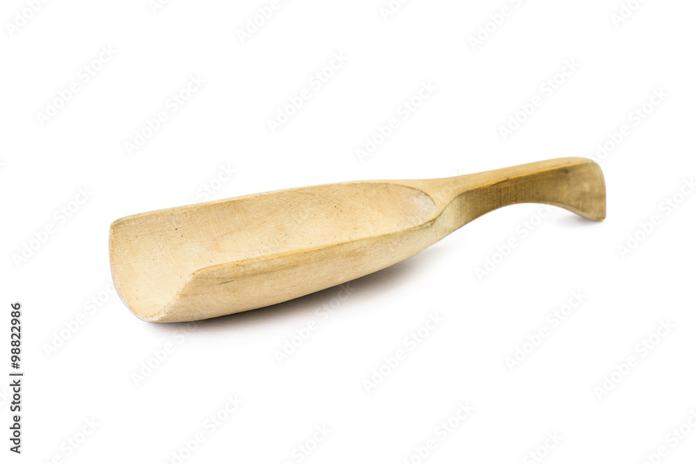 Close up of wooden spoon on white background seen from the side Close up of wooden spoon on white background seen from the side