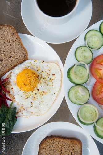 Coffee cup, scrambled eggs and salad photo