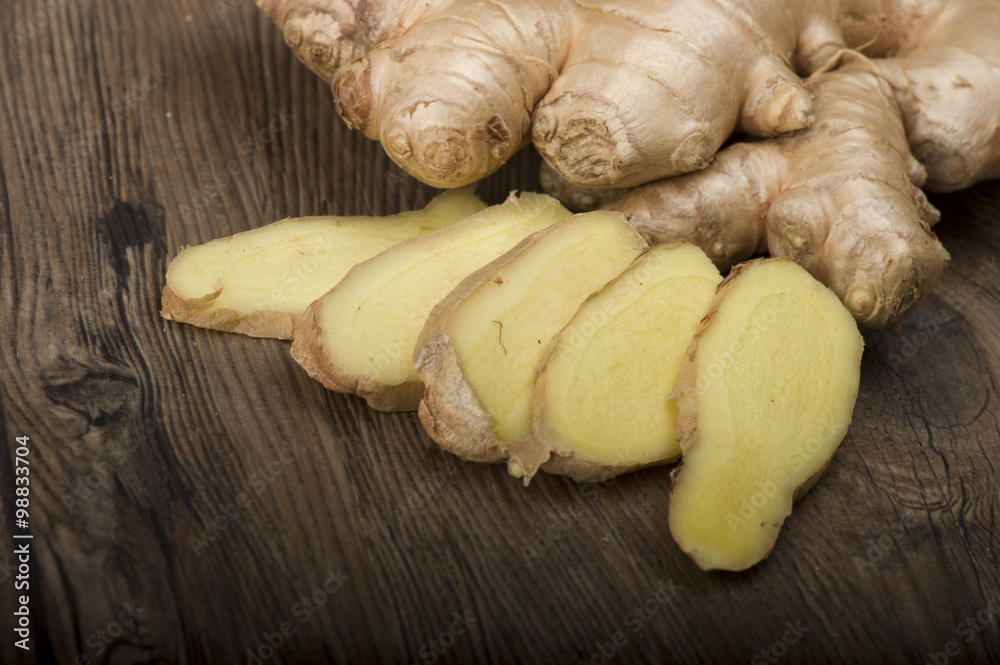 Ginger root sliced on the wooden table Ginger root sliced on the wooden table