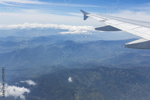 Aerial view of Andean mountains and airplane wing, Colombia