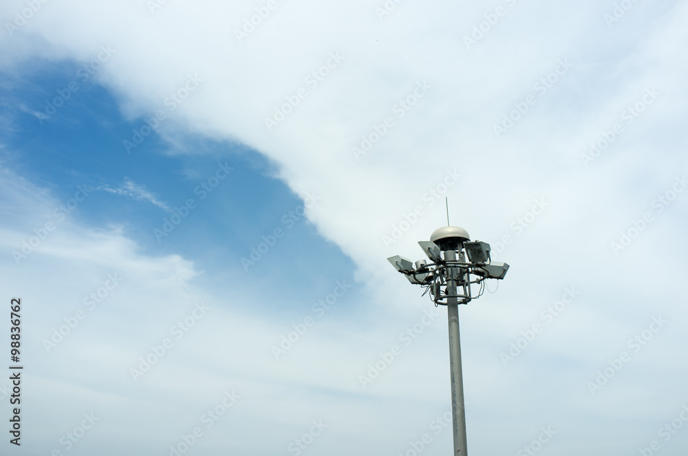 Spotlight pole with blue sky and white cloud background Spotlight pole with blue sky and white cloud background
