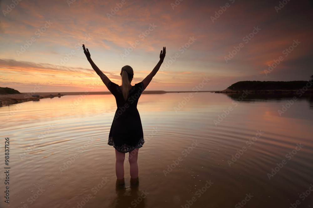 Woman outstretched arms praising perfect day success