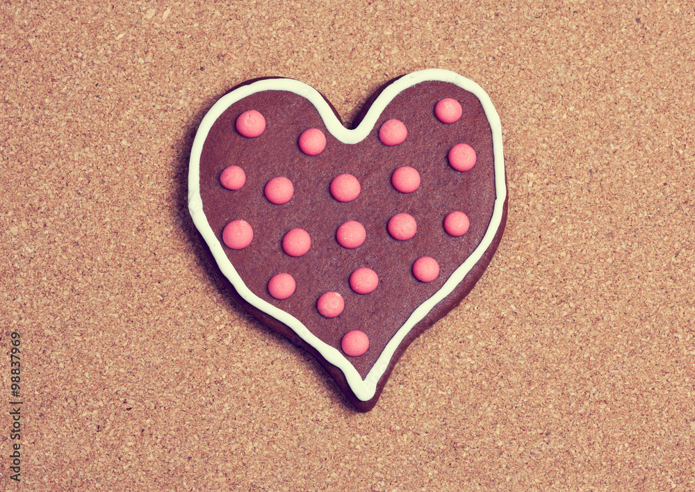 Heart shaped cookie on cork surface Heart shaped cookie on cork surface