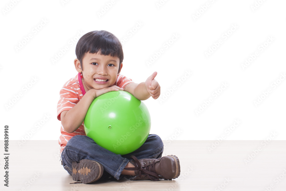 Fototapeta premium Little boy playing green ball