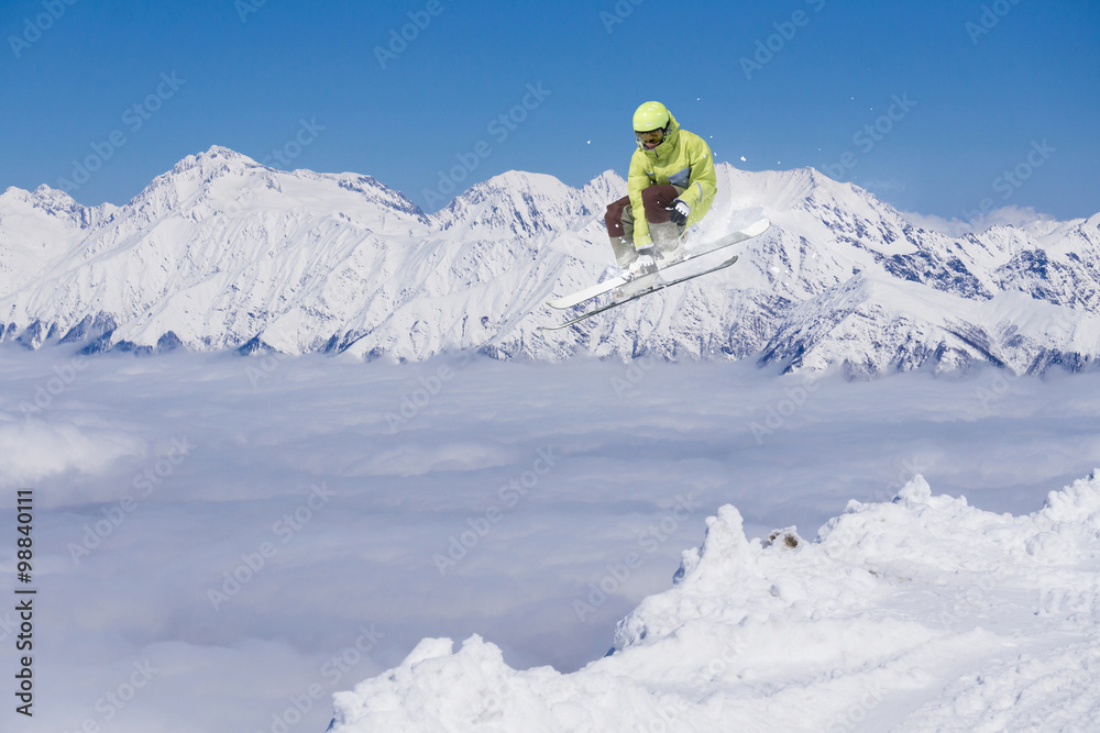 Flying skier on mountains. Extreme sport.