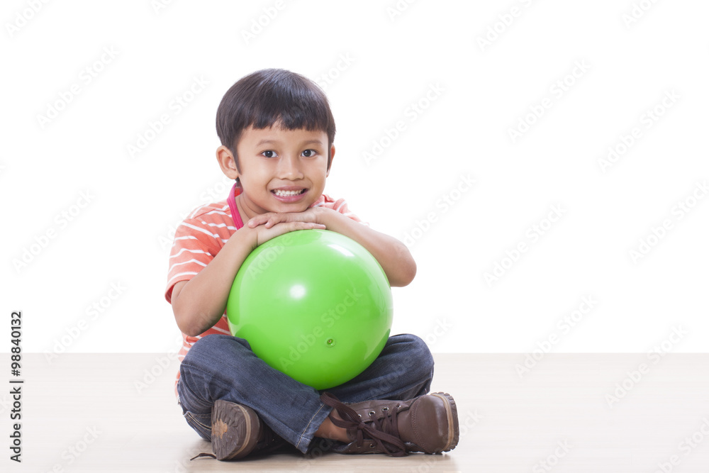 Fototapeta premium Little boy playing green ball 
