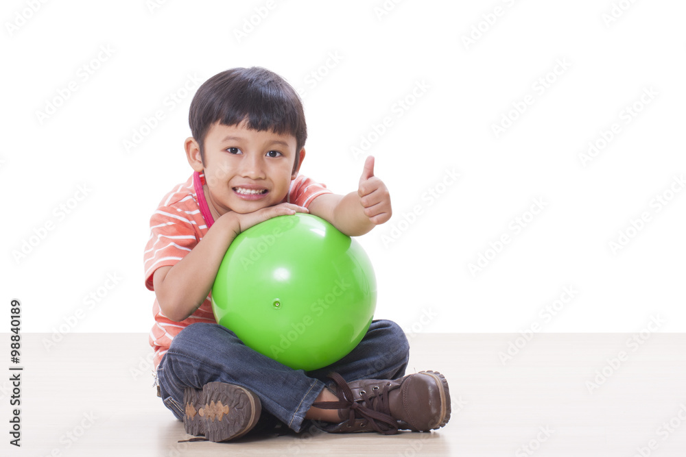 Fototapeta premium Little boy playing green ball 