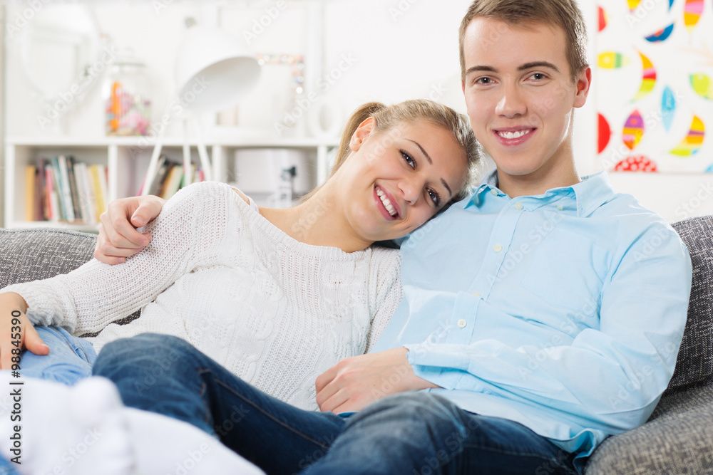 Loving couple laid back and anjoying their time together in the living room Loving couple laid back and anjoying their time together in the living room