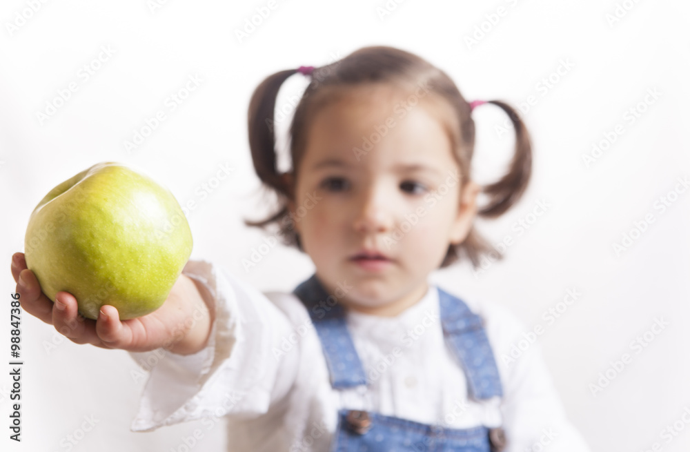 Little girl holding a green apple Little girl holding a green apple