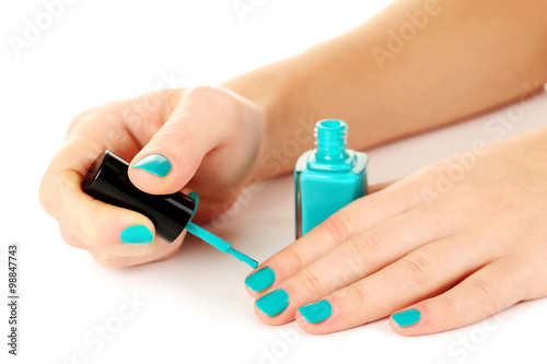 Nail polish in the woman hand on a white background