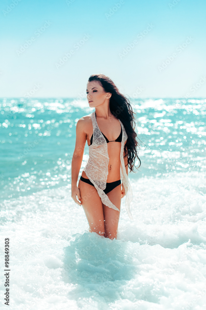 Sexy woman on beach in the water